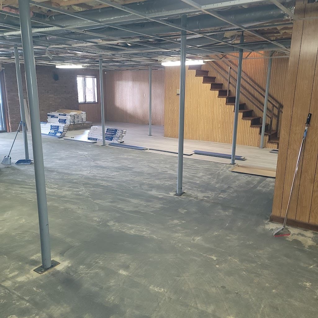 Gutted commercial interior mid-remodel, with materials staged for new flooring